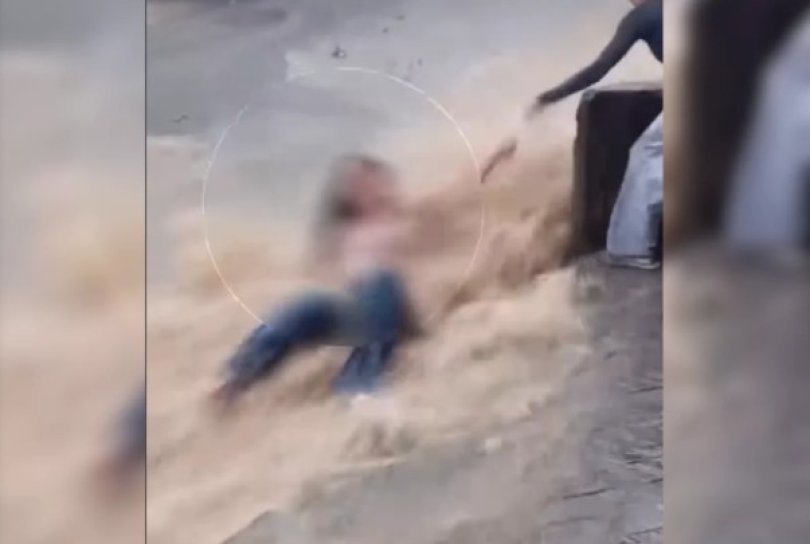 Jovem resgatada aps ser arrastada por enxurrada na rua | FOLHAMAX